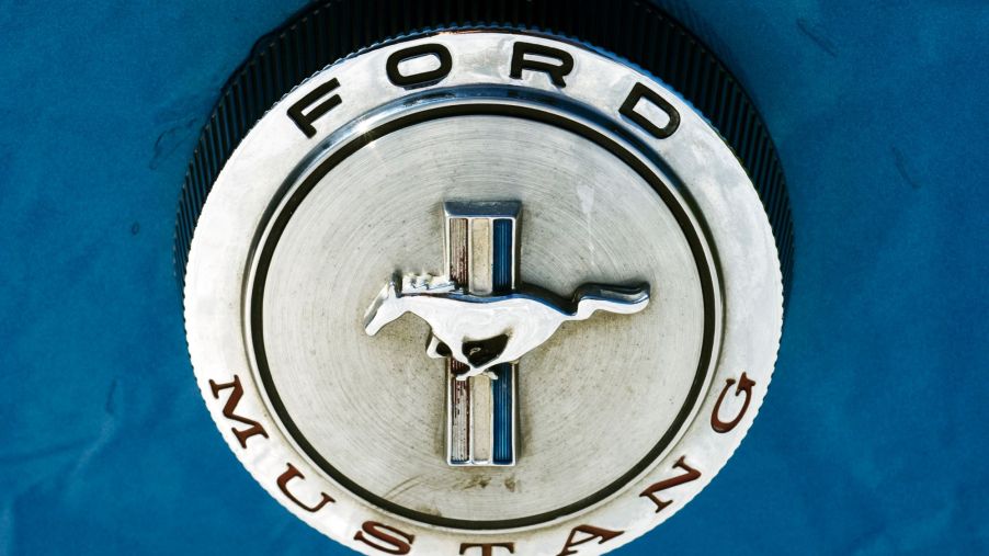 A silver Ford Mustang logo on a blue car.