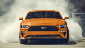 Front view of orange 2022 Ford Mustang, one of the cheapest sports cars