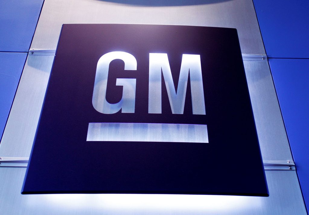 A silver and blue general motors (GM) logo.