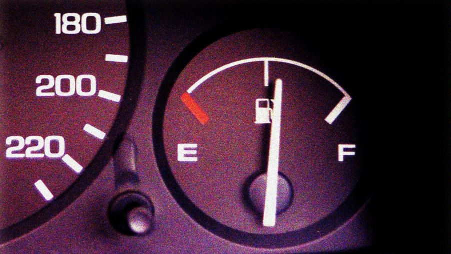 A black gas gauge to assist in monitoring car fluids showing a half a tank.