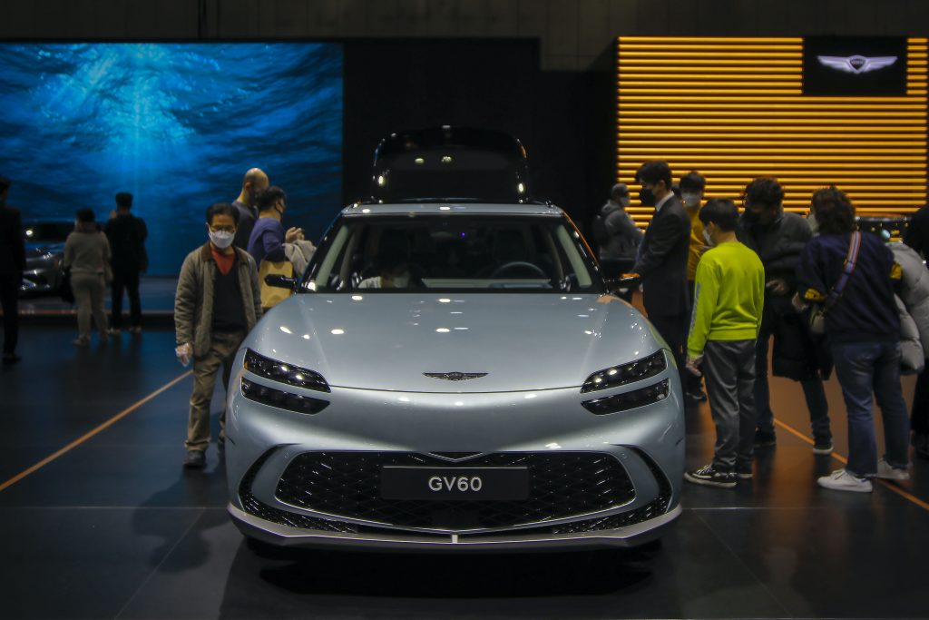 Visitors look at GENESIS GV60 at the 2021 SEOUL AUTOMOBILITY SHOW. 