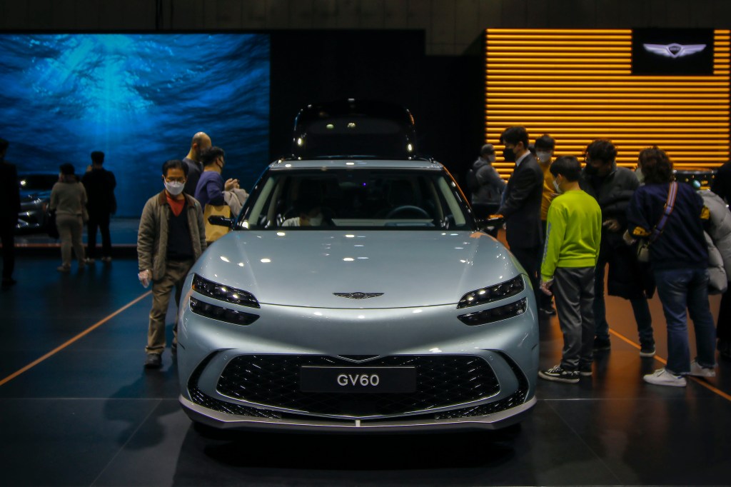 Visitors look at GENESIS GV60 at the 2021 SEOUL AUTOMOBILITY SHOW. 