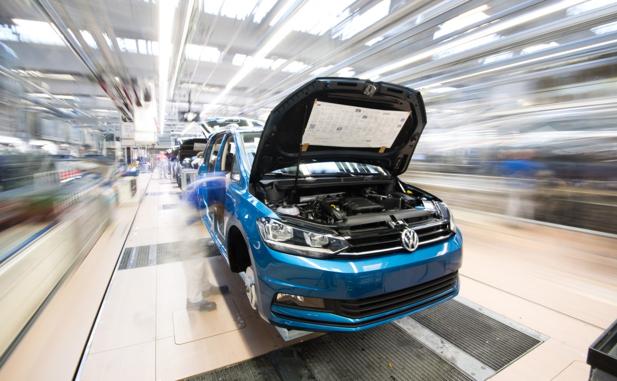 A blue Volkswagon Touran on the assembly line in the factory.