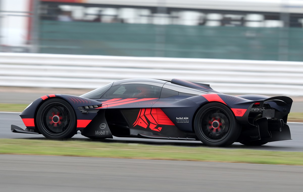 An Aston Martin Valkyrie, in profile view, on the Silverstone race circuit.