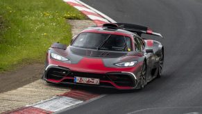 A Mercedes-AMG One supercar clipping the apex of a corner at the Nurburgring race track in Germany