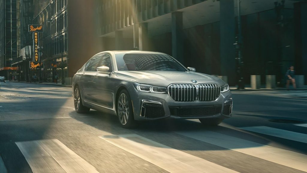 Gray 2022 BMW 7 Series driving on a city street