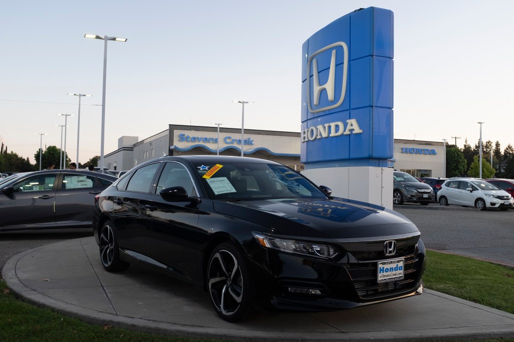 Honda logo and Honda Accord vehicle are seen at a store in San Jose, California.