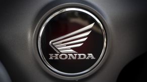 Honda motorsports logo in black and silver on a grey background.