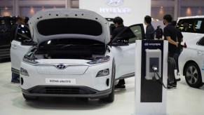 A white Hyundai Kona Electric is on display.