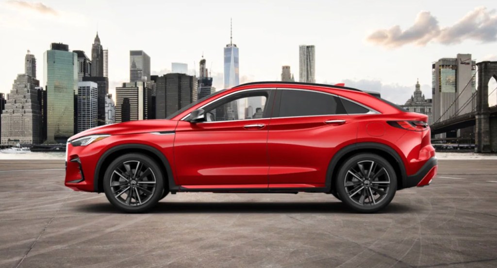 A red 2022 Infiniti QX55 is driving on the street. 