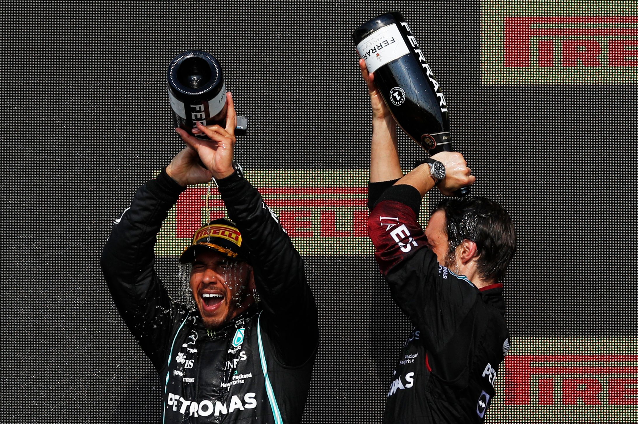 Lewis Hamilton celebrates with a champagne bath on the podium of the British Grand Prix