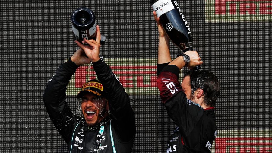 Lewis Hamilton celebrates with a champagne bath on the podium of the British Grand Prix