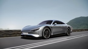 The silver Mercedes Vision EQXX Concept driving down a road