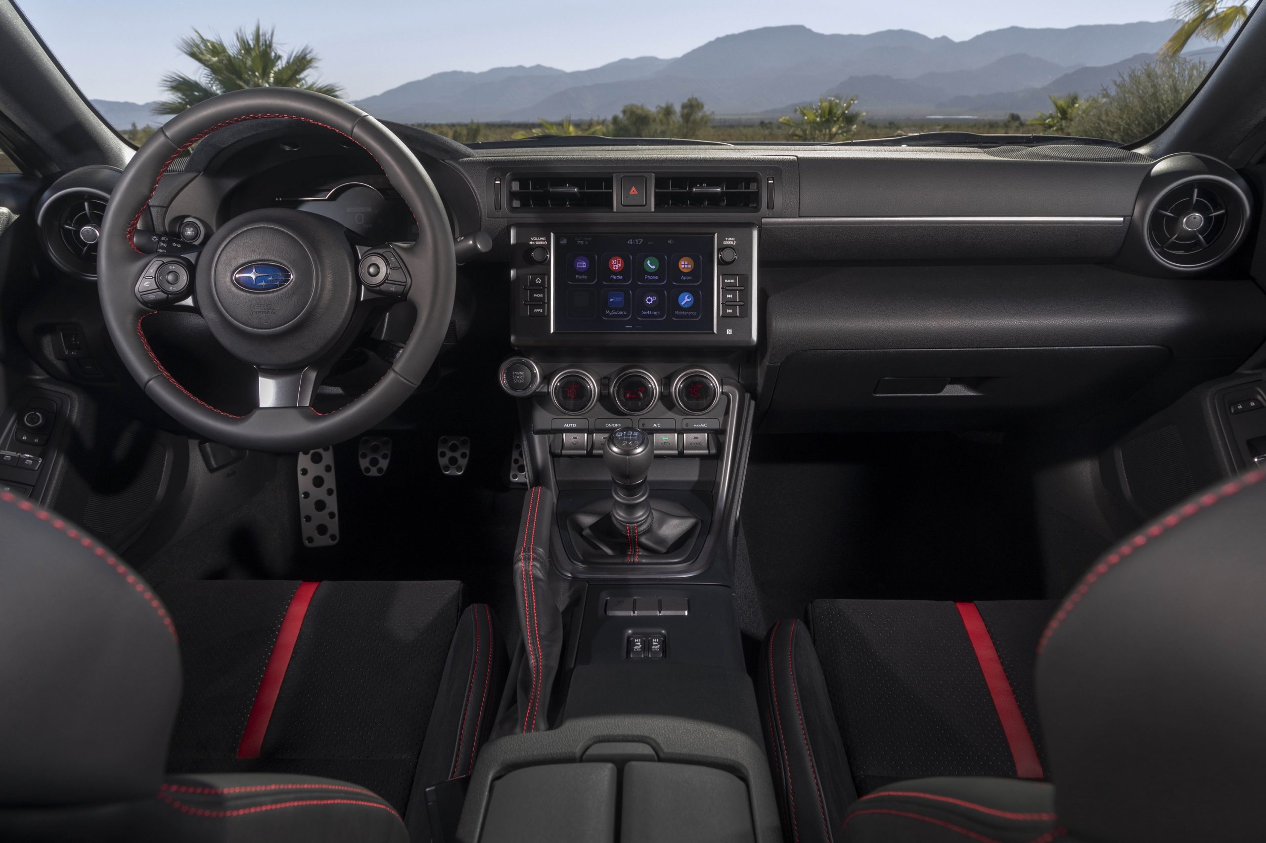 The black-and-red seats and black dashboard of a new 2022 Subaru BRZ sports car with a manual transmission