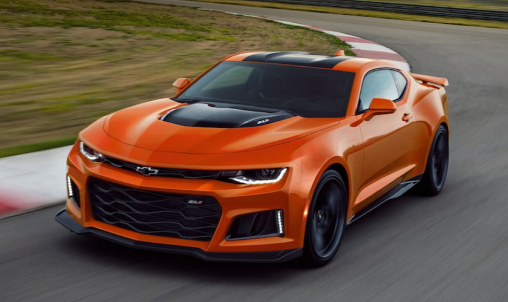 Orange and black 2022 Chevrolet Camaro, the most affordable sports car, driving on a racetrack