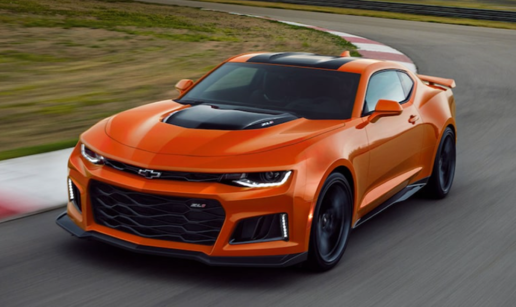 Orange and black 2022 Chevrolet Camaro, the most affordable sports car, driving on a racetrack