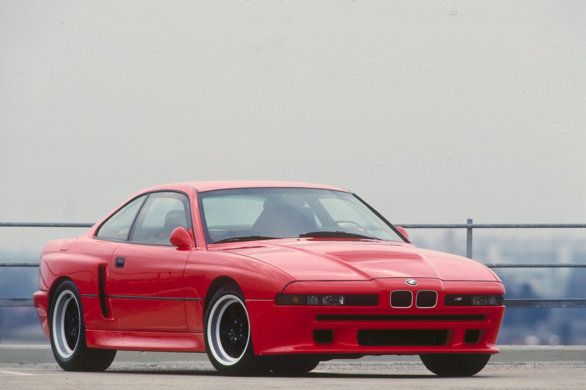 A 3/4 front view of the red BMW E31 M8 prototype.