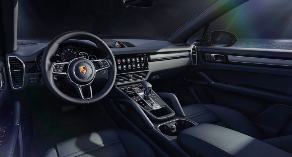 The interior of a black 2022 Porsche Cayenne Platinum Edition luxury SUV. 