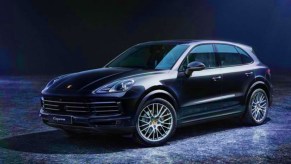 A black Porsche Cayenne Platinum Edition luxury SUV is parked.