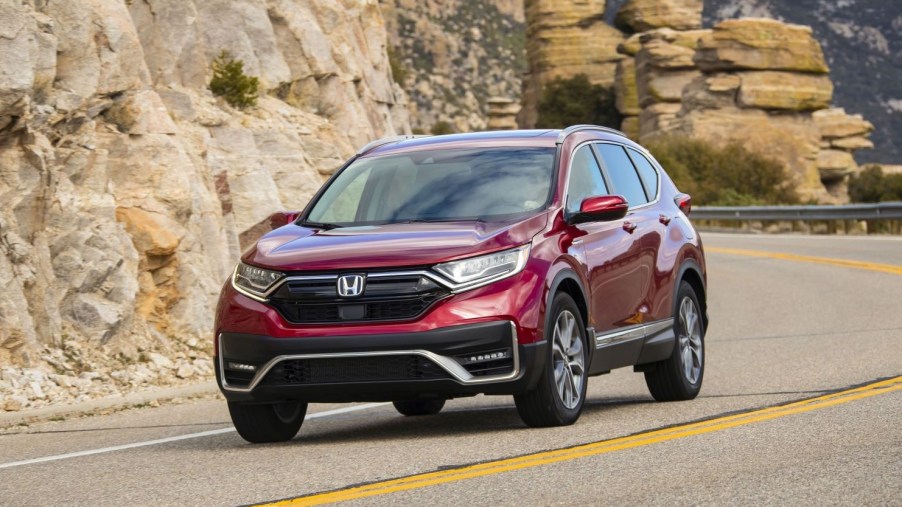 Radiant Red Metallic 2022 Honda CR-V driving by rock formations
