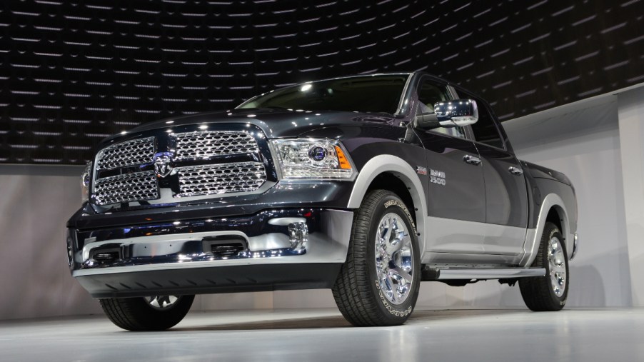A black Ram 1500 truck is on display.