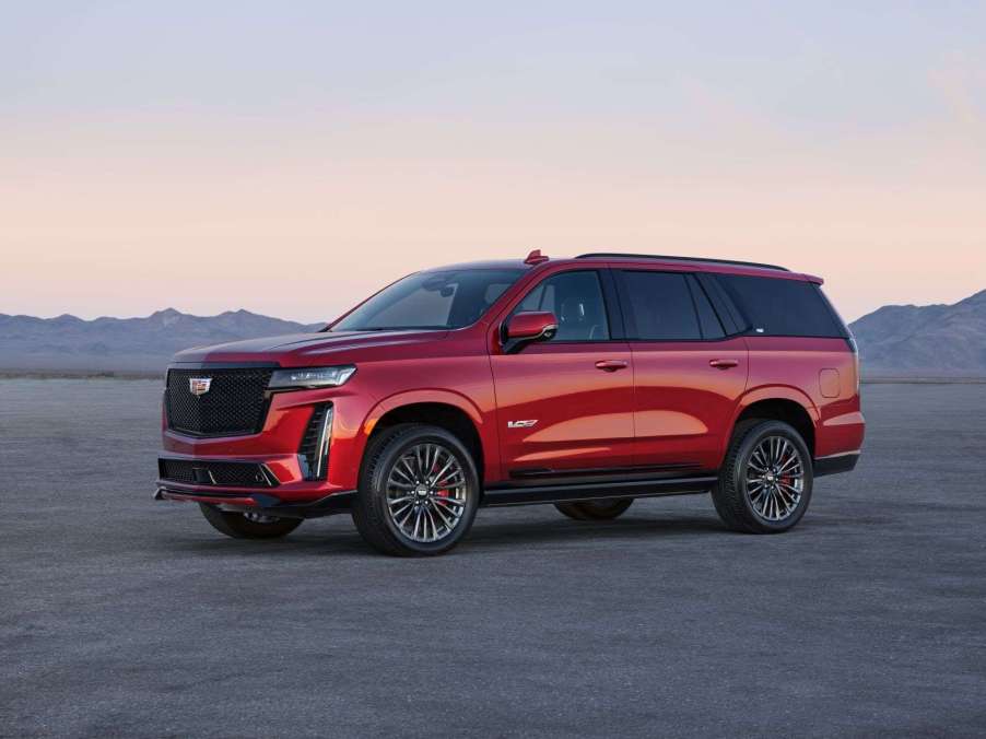 Red 2023 Cadillac Escalade V with mountains in the background