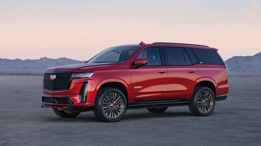 Red 2023 Cadillac Escalade V with mountains in the background