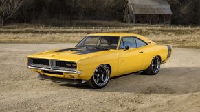 A yellow 1969 Dodge Charger restomod with a Hellcat V8 shot from the 3/4 angle