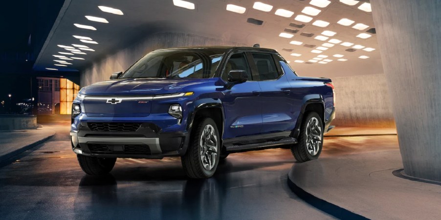 A blue 2022 Chevy Silverado EV turning a corner.