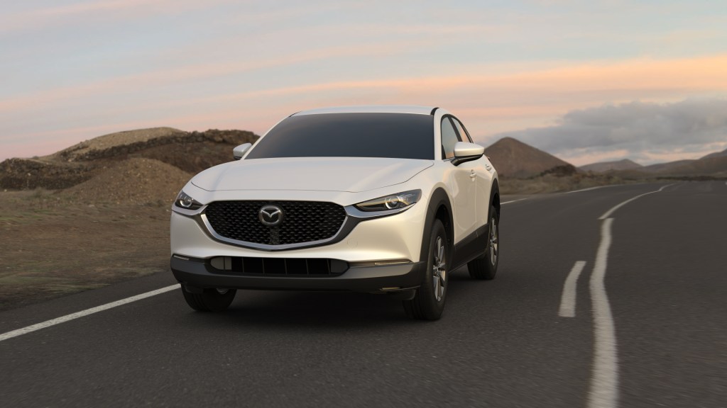 Snowflake White Pearl Mica 2022 Mazda CX-30 driving on a desert highway