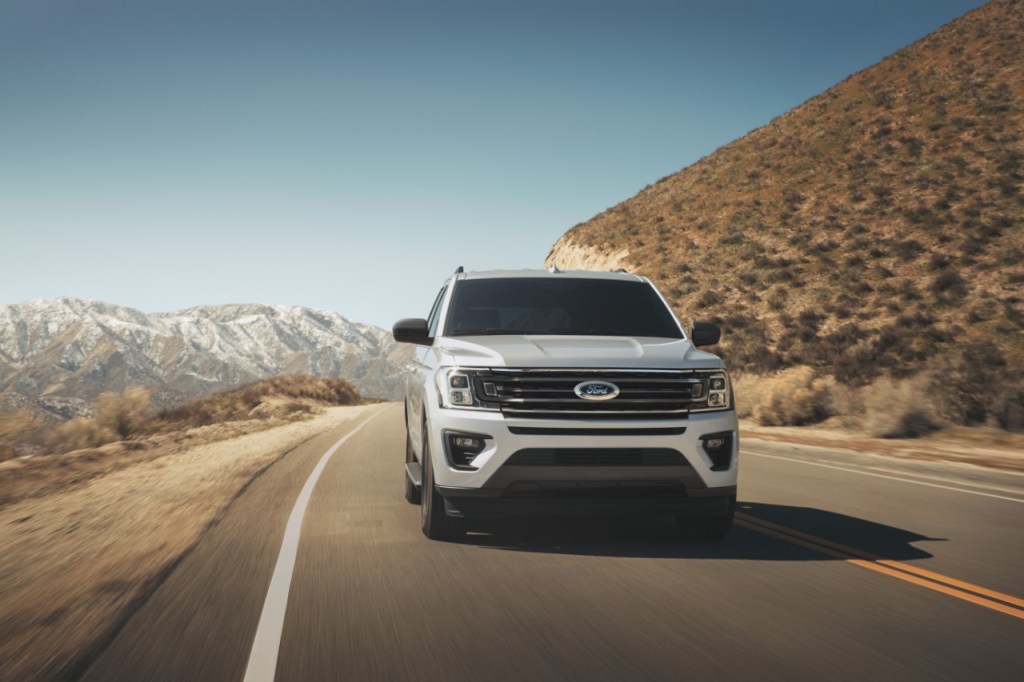 Star White 2022 Ford Expedition with mountains in the background has the best towing capacity of any SUV on the market. 