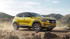 Starbright Yellow 2022 Kia Seltos parked near a pile of rocks