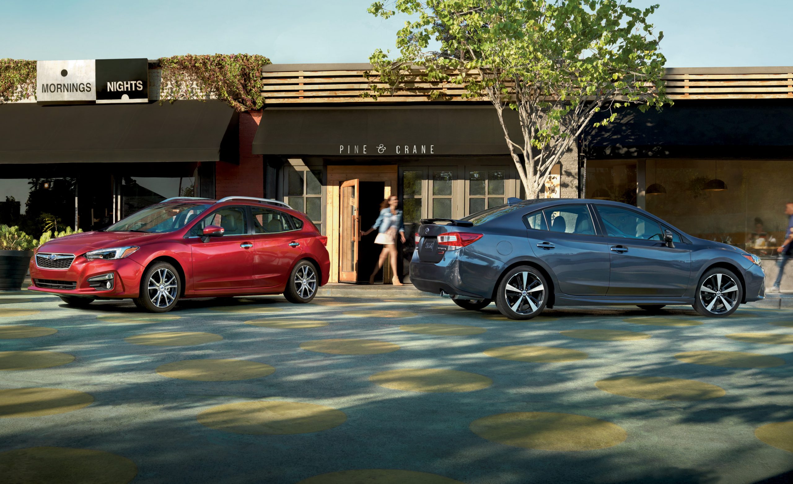 A pair of Subaru Impreza models, one a station wagon and the other a sedan
