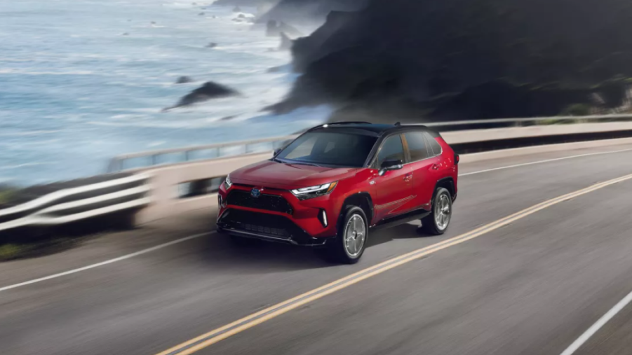 Supersonic Red 2022 Toyota RAV4 Prime driving on a coastal road
