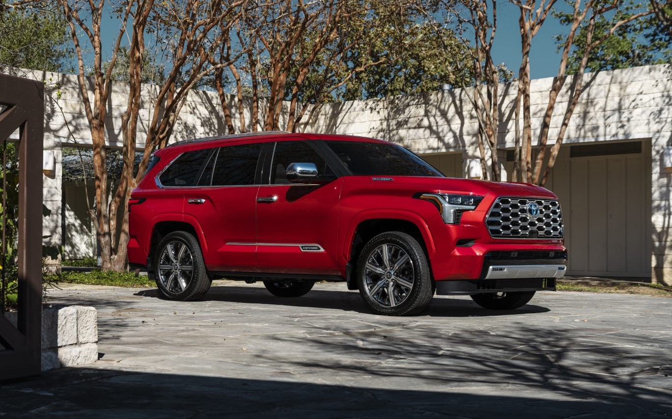 Supersonic Red 2023 Toyota Sequoia Capstone parked in front of trees