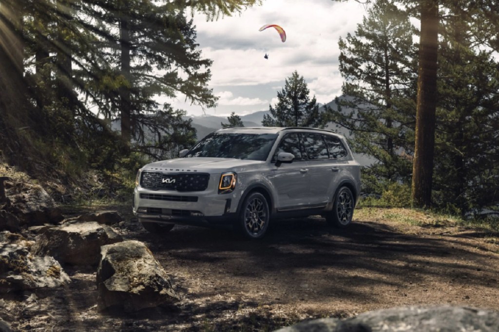 A slate gray 2022 Kia Telluride parked in the woods.
