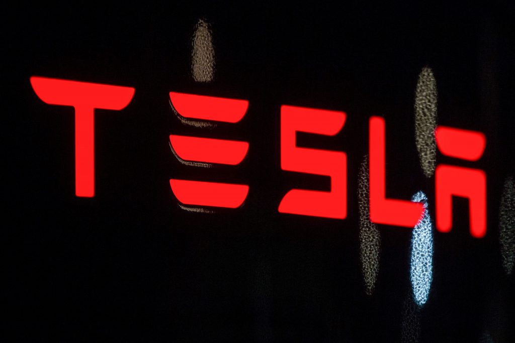 Tesla written out in red on a black background