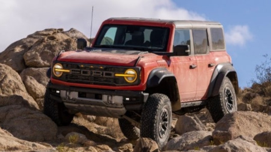 The 2022 Ford Bronco Raptor is climbing rocks.