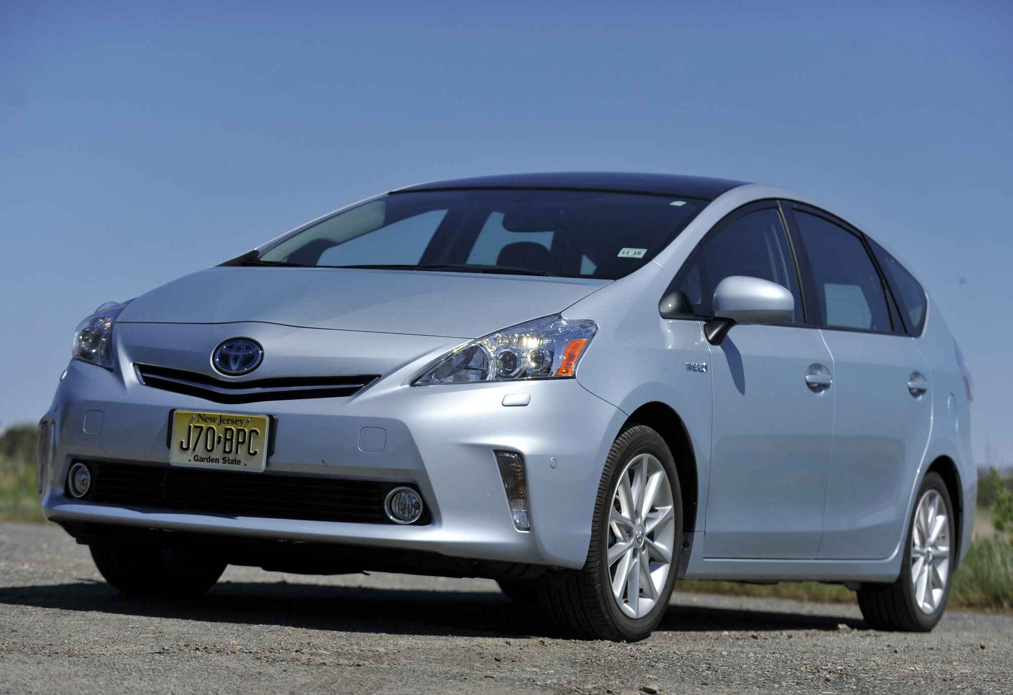 A silver Toyota Prius subcompact hybrid shot from the front 3/4
