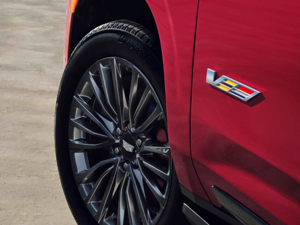 V badge and wheel on red 2023 Cadillac Escalade V