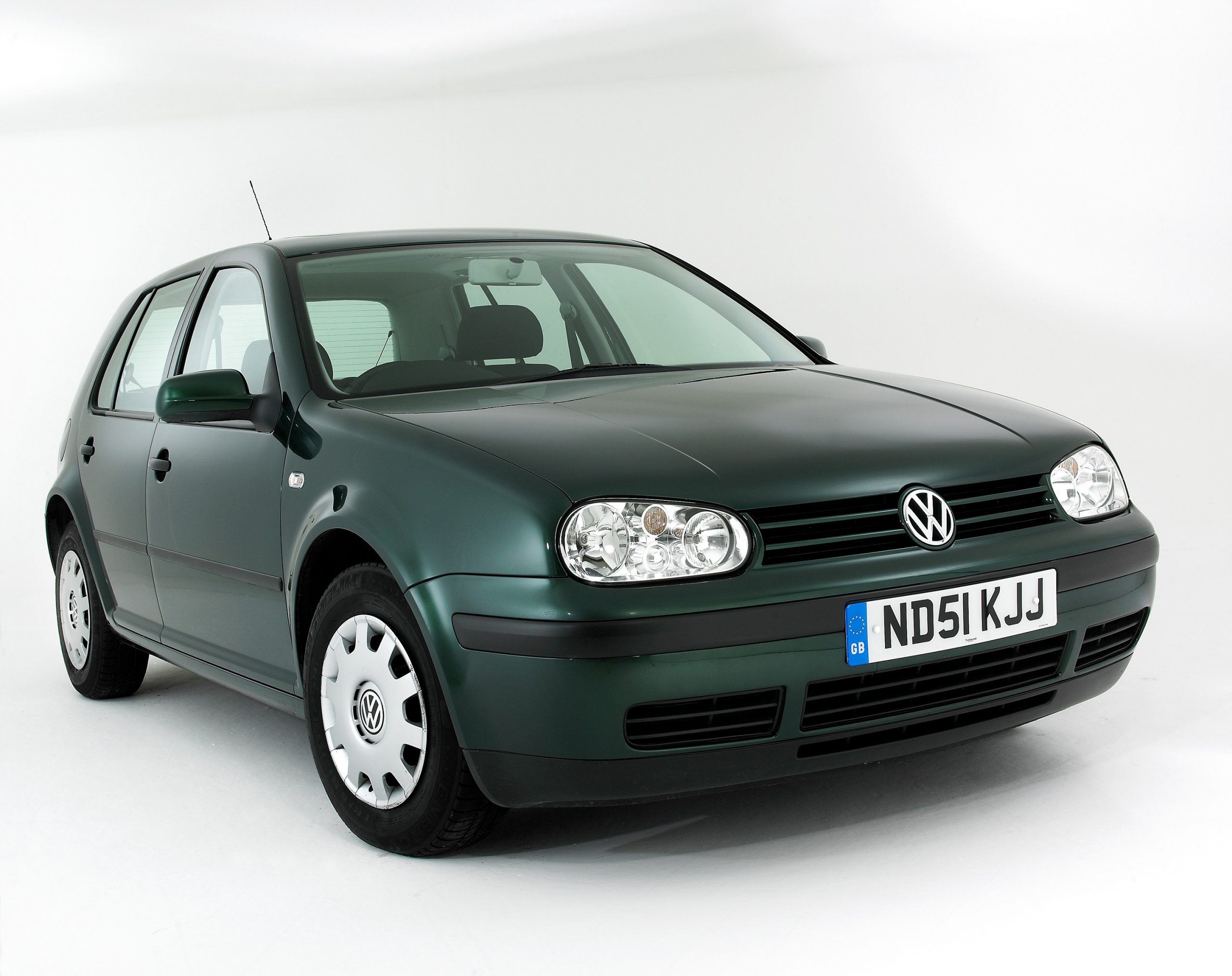 A green Volkswagen Golf subcompact car shot from the front 3/4