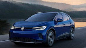 A blue Volkswagen ID.4 is driving on the road.