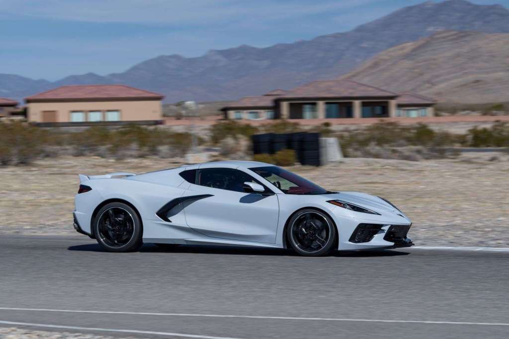 White 2022 Chevy Corvette Stingray, the Consumer Reports most satifying car, driving on a racetrack