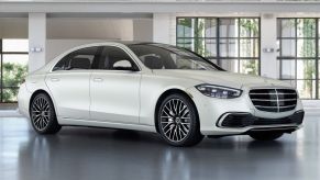 White fully loaded new 2022 Mercedes-Benz S-Class S 580 4MATIC Executive Line parked near a house