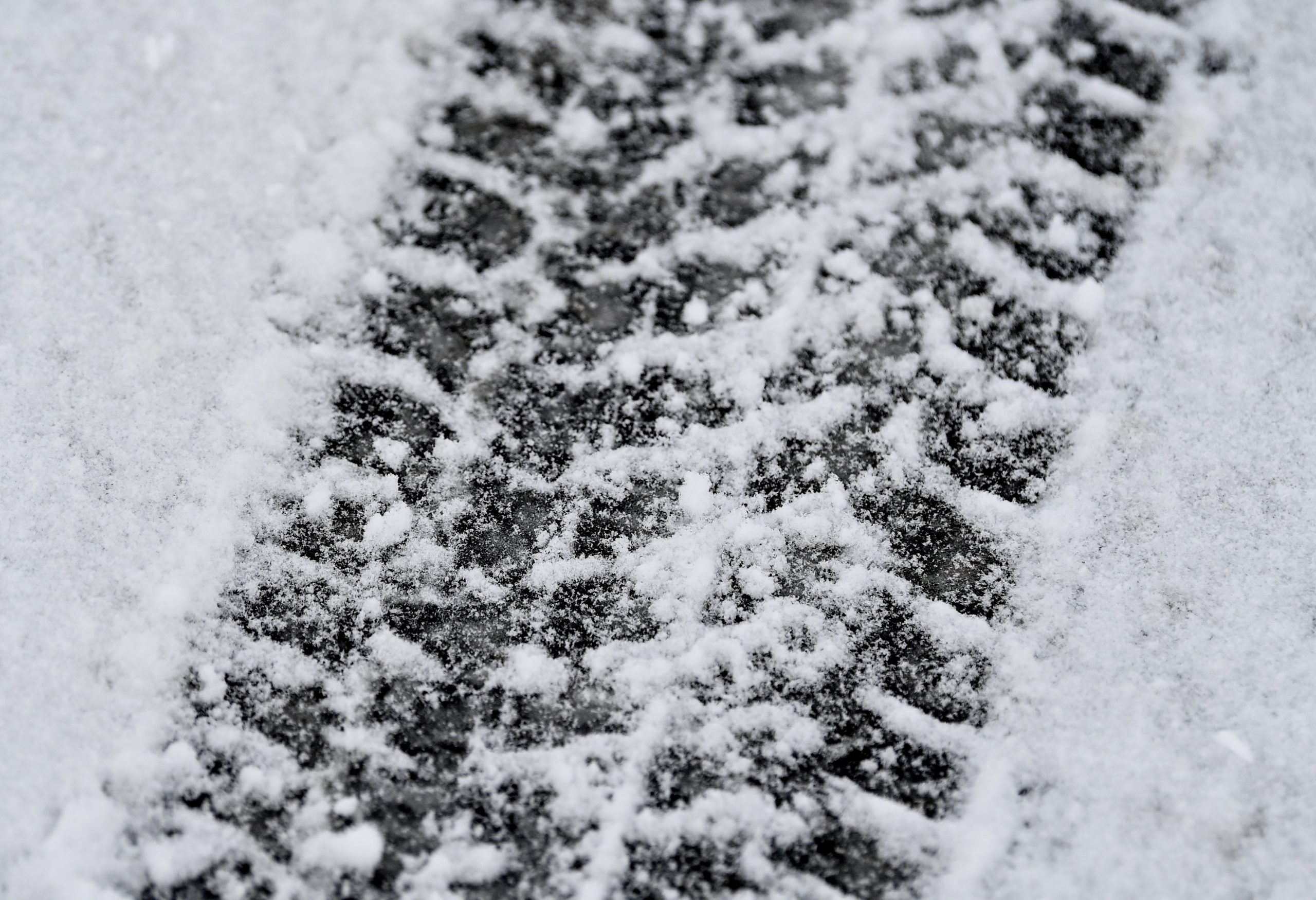The tracks left by a car tire in the snow