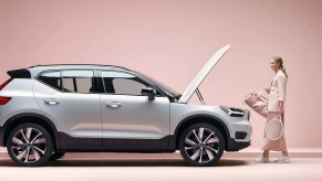 A silver 2022 Volvo XC40 Recharge against a pink background.