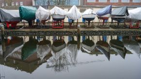 Boats covered and docked on land during winter in Mecklenburg-Wester Pomerania, Stralsund by the Baltic Sea
