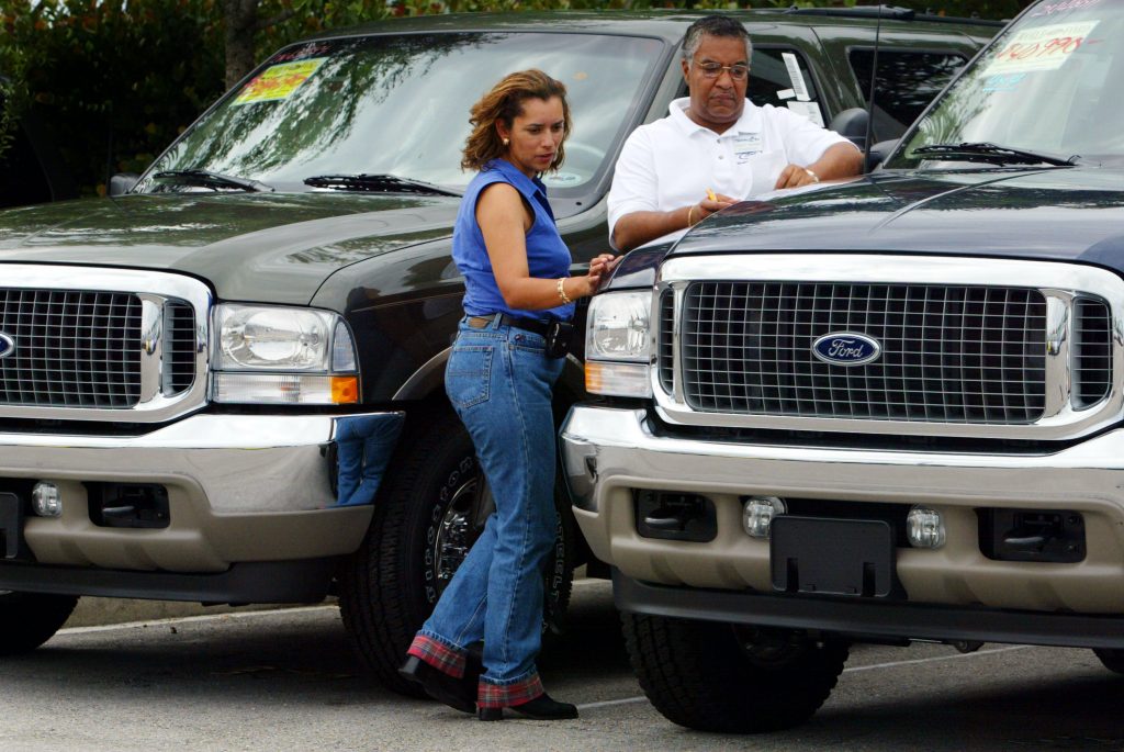 A customer gets her car appraised by a Ford dealer
