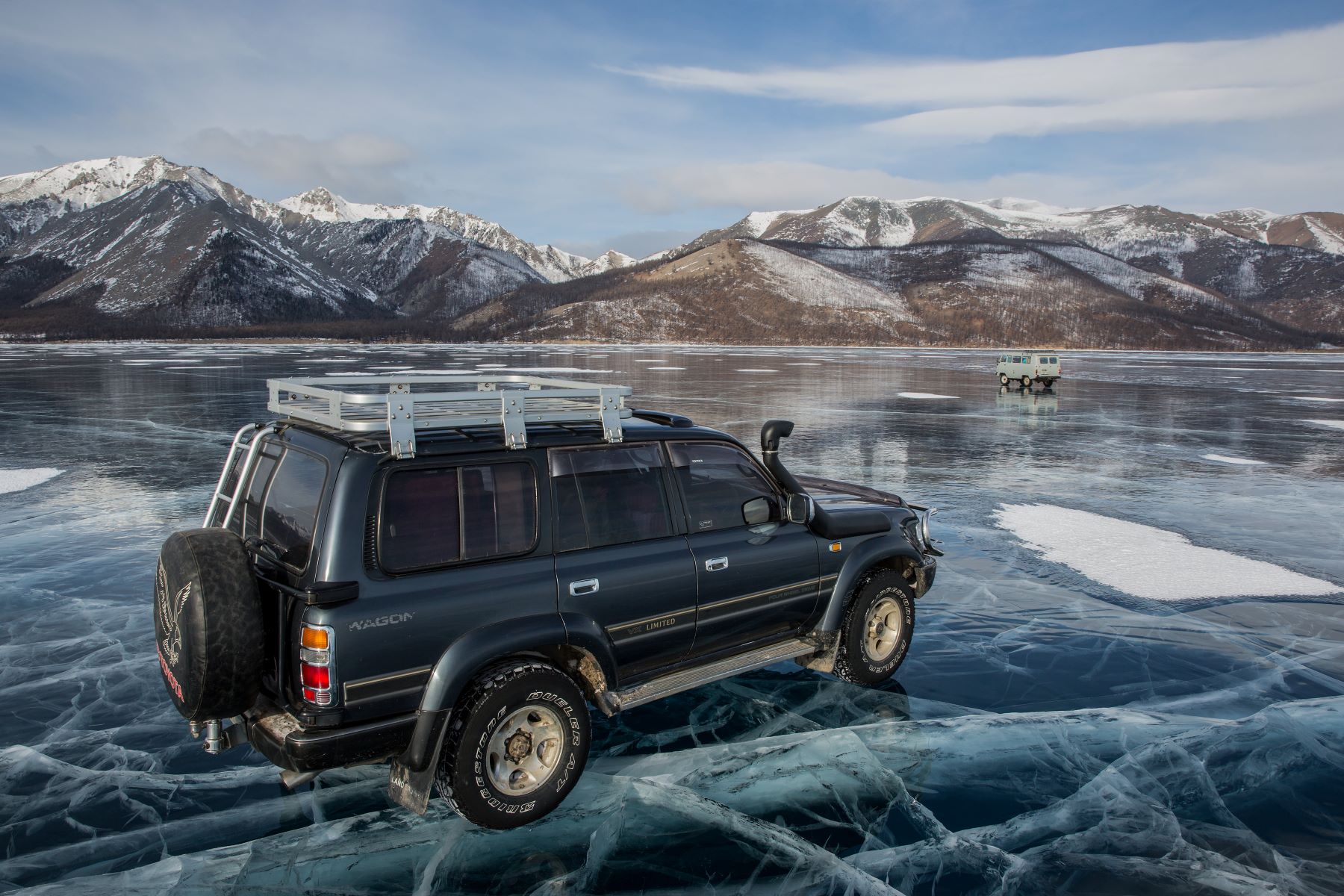 An SUV driving on top of a frozen lake in the Khovsgol Province of Mongolia
