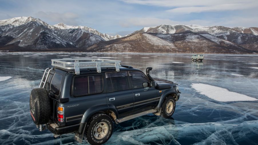 An SUV driving on top of a frozen lake in the Khovsgol Province of Mongolia
